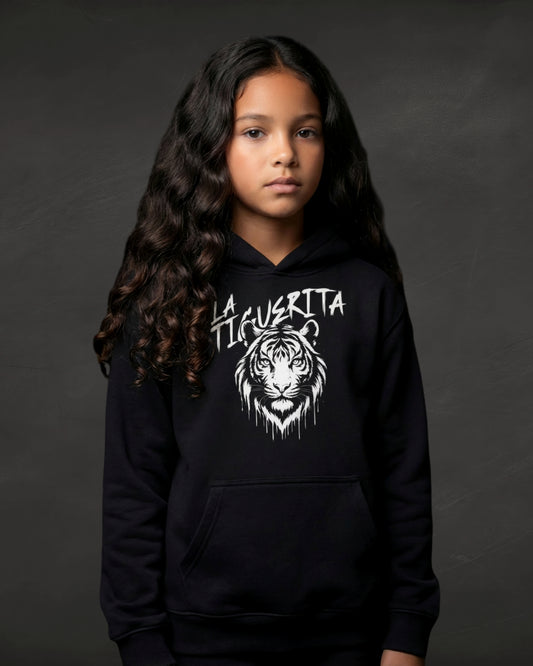 Young girl wearing a black hoodie with a tiger graphic and text on a dark background