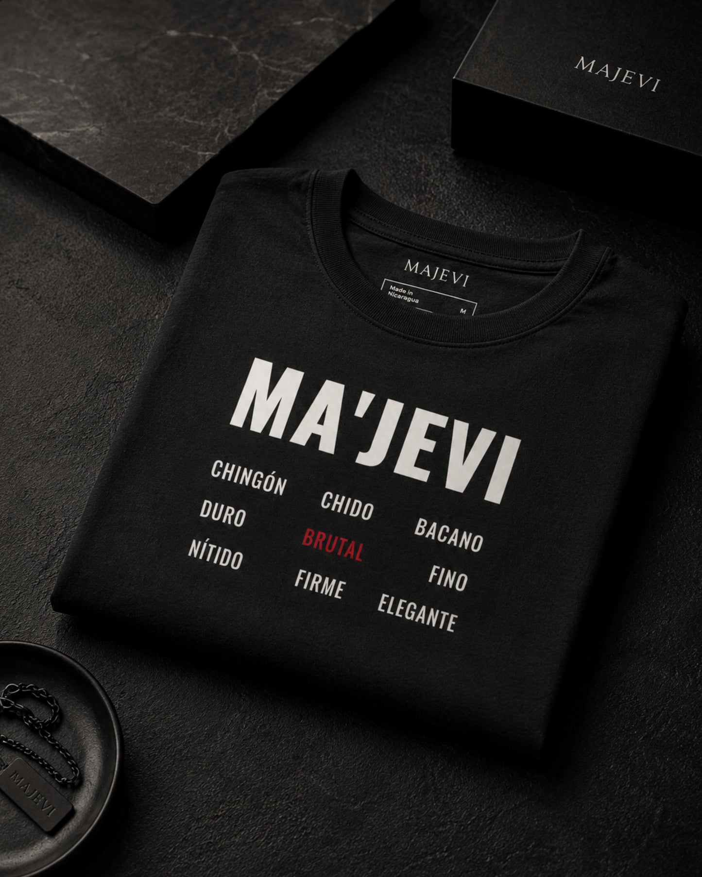 Black sweatshirt with 'MA'JEVI' branding and text on a dark surface