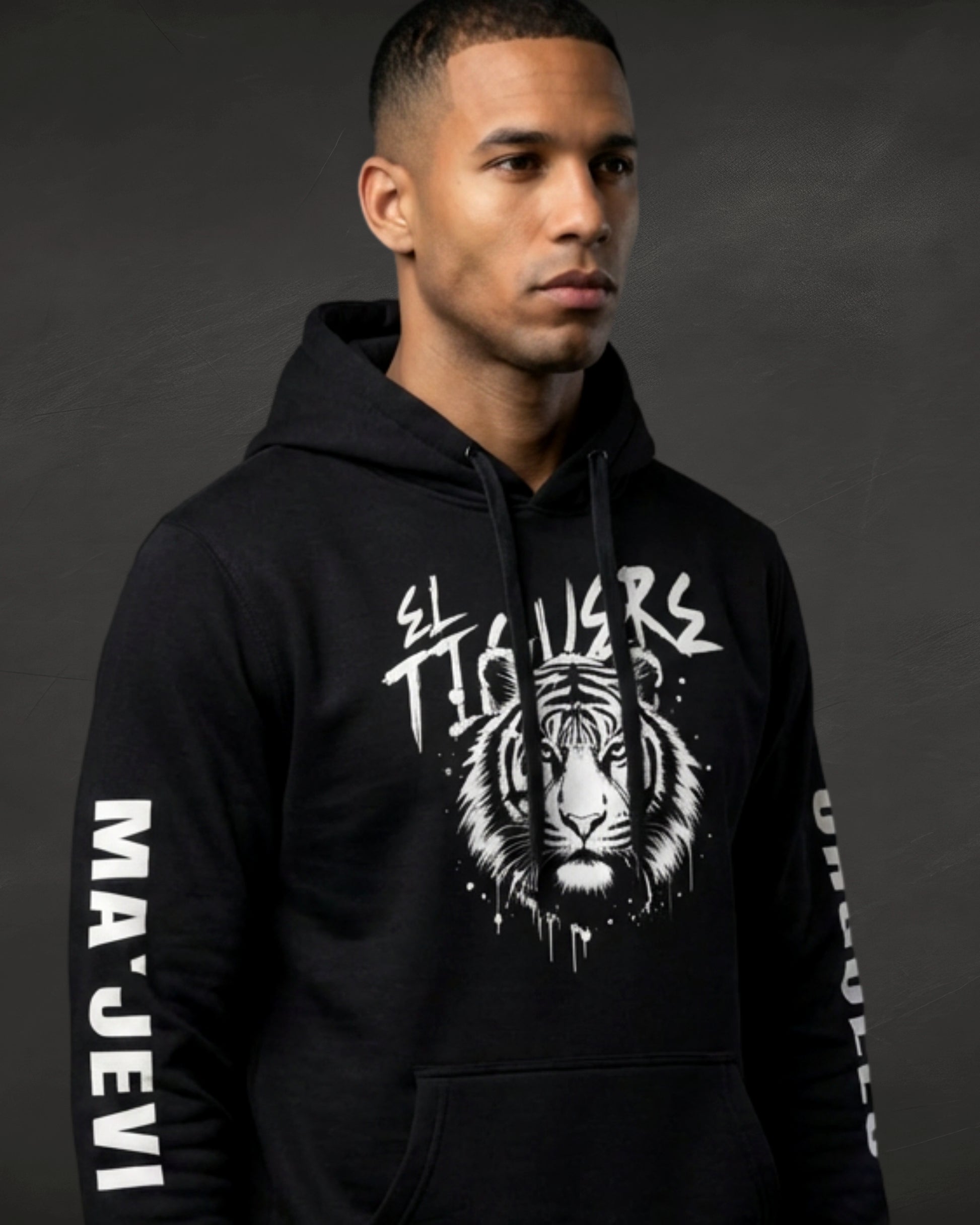 Person wearing a black hoodie with a tiger graphic and text on a dark background