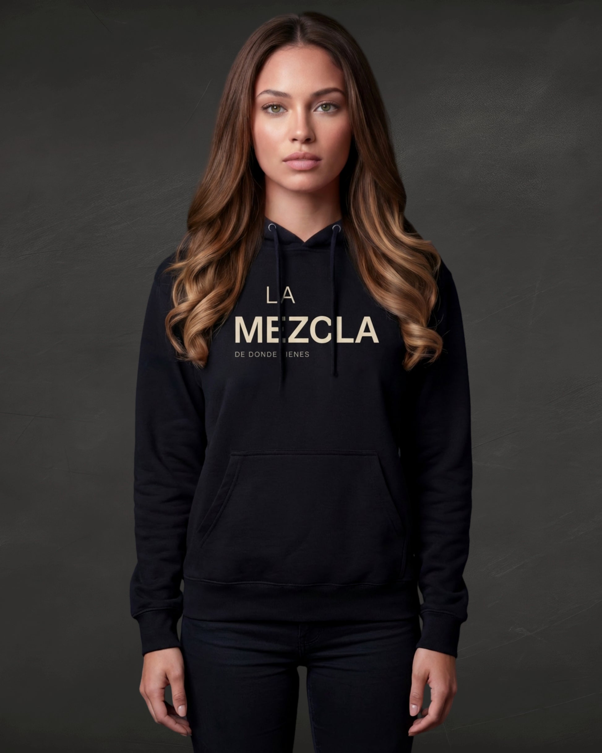 Woman wearing a black hoodie with 'LA MEZCLA' text on a dark background