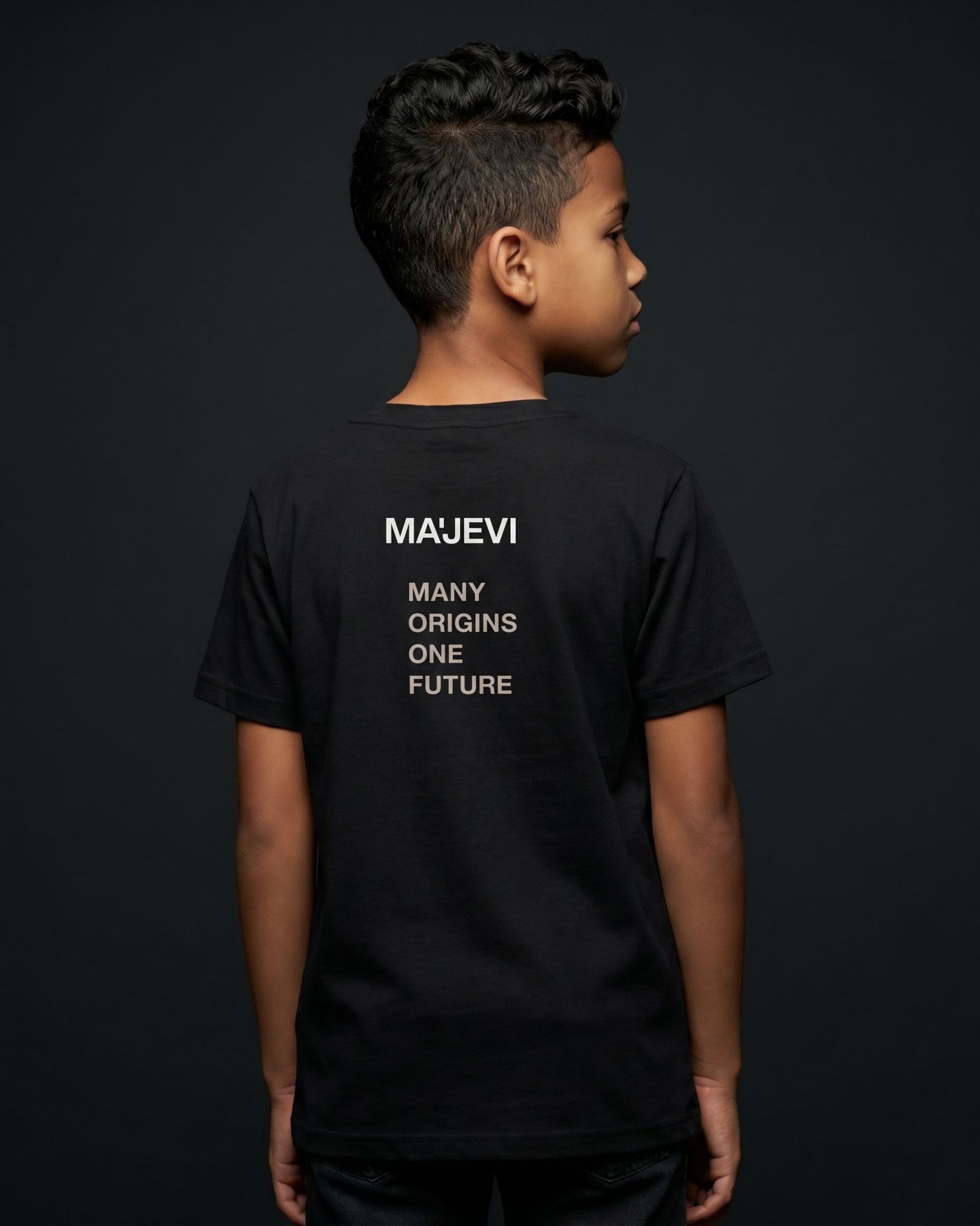 Person wearing a black t-shirt with 'MAJEVI' text on the back against a dark background
