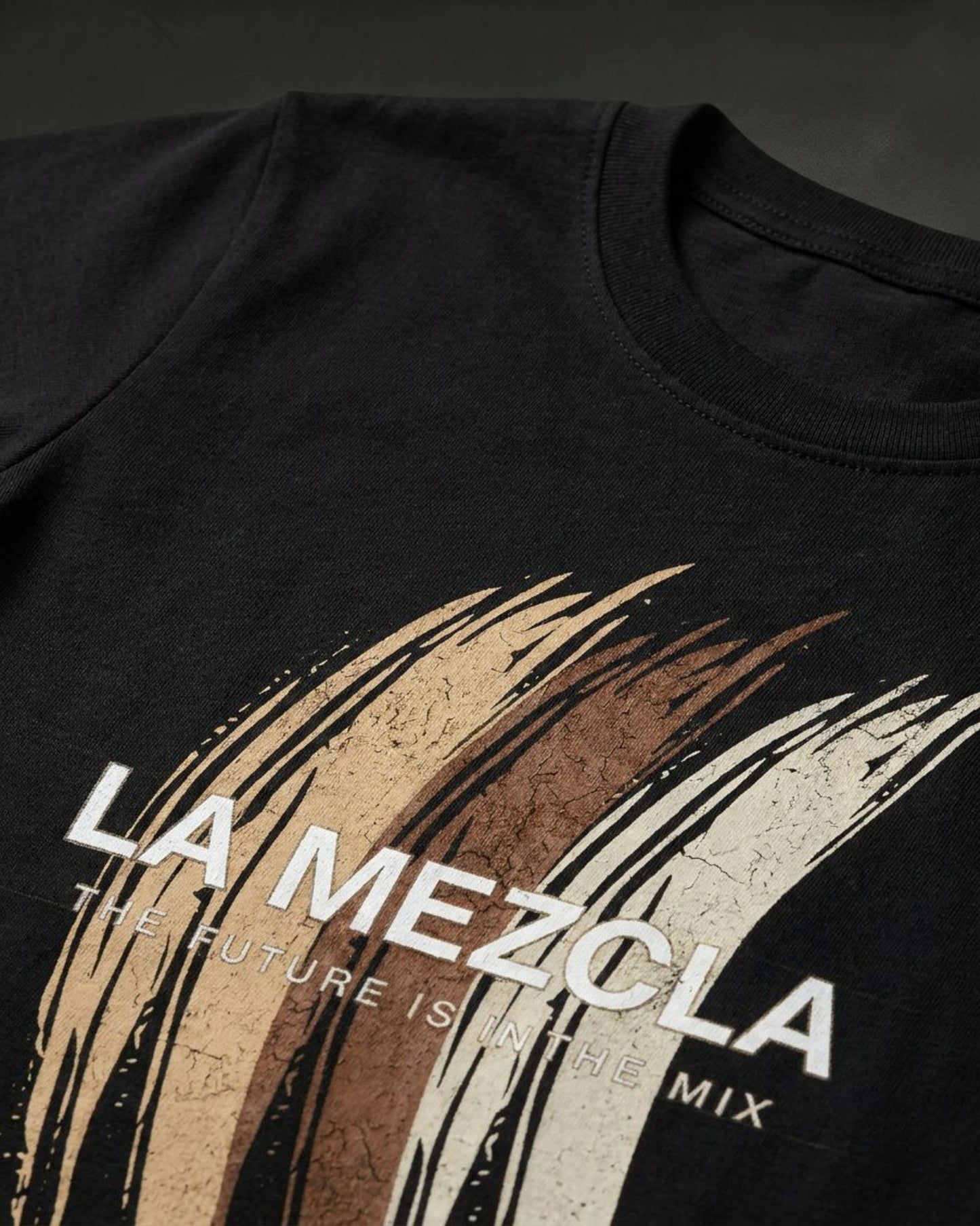 Black t-shirt with 'La Mezcla' graphic design on a dark background