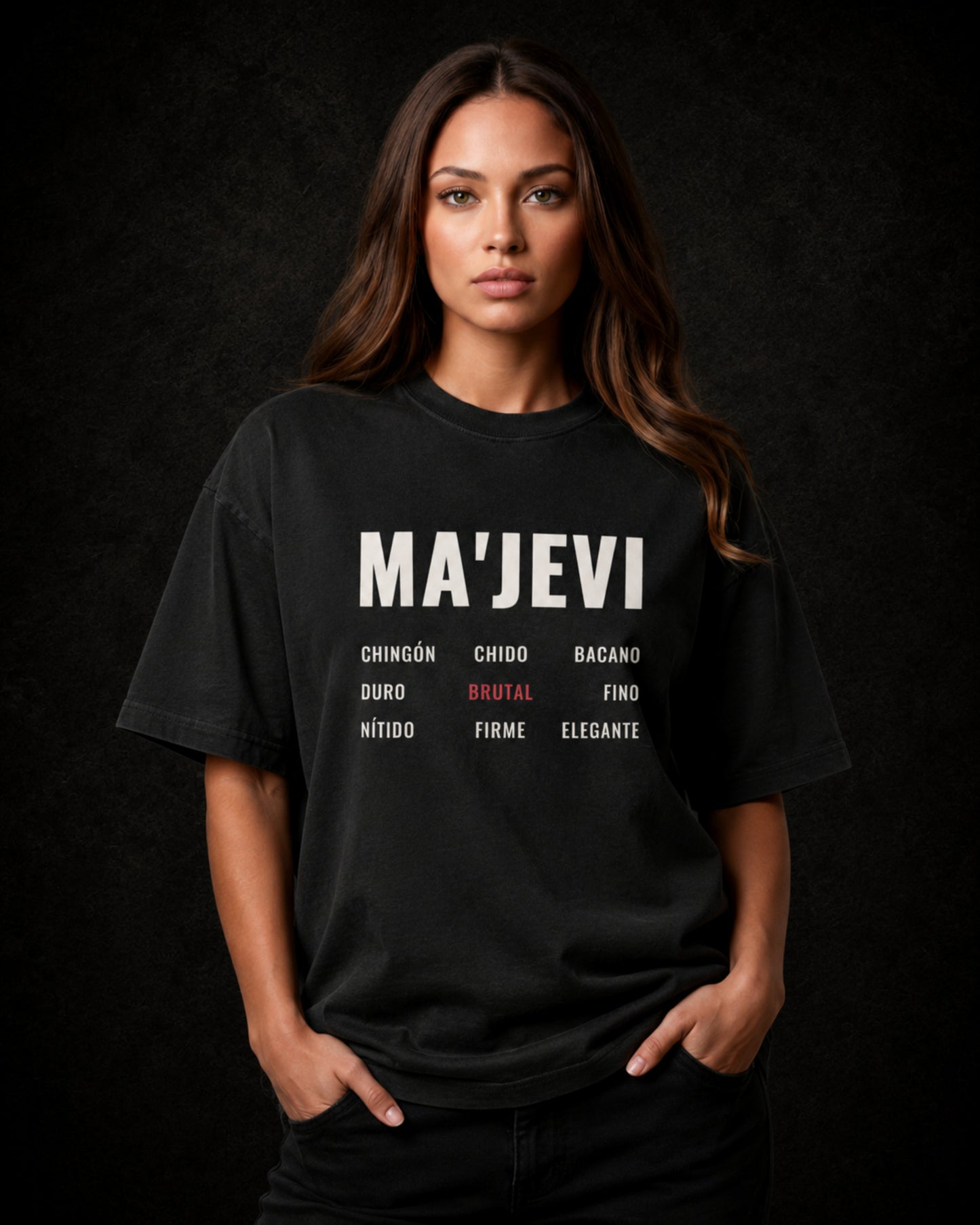 Latina wearing a washed black t-shirt with 'MA'JEVI' text on a dark background