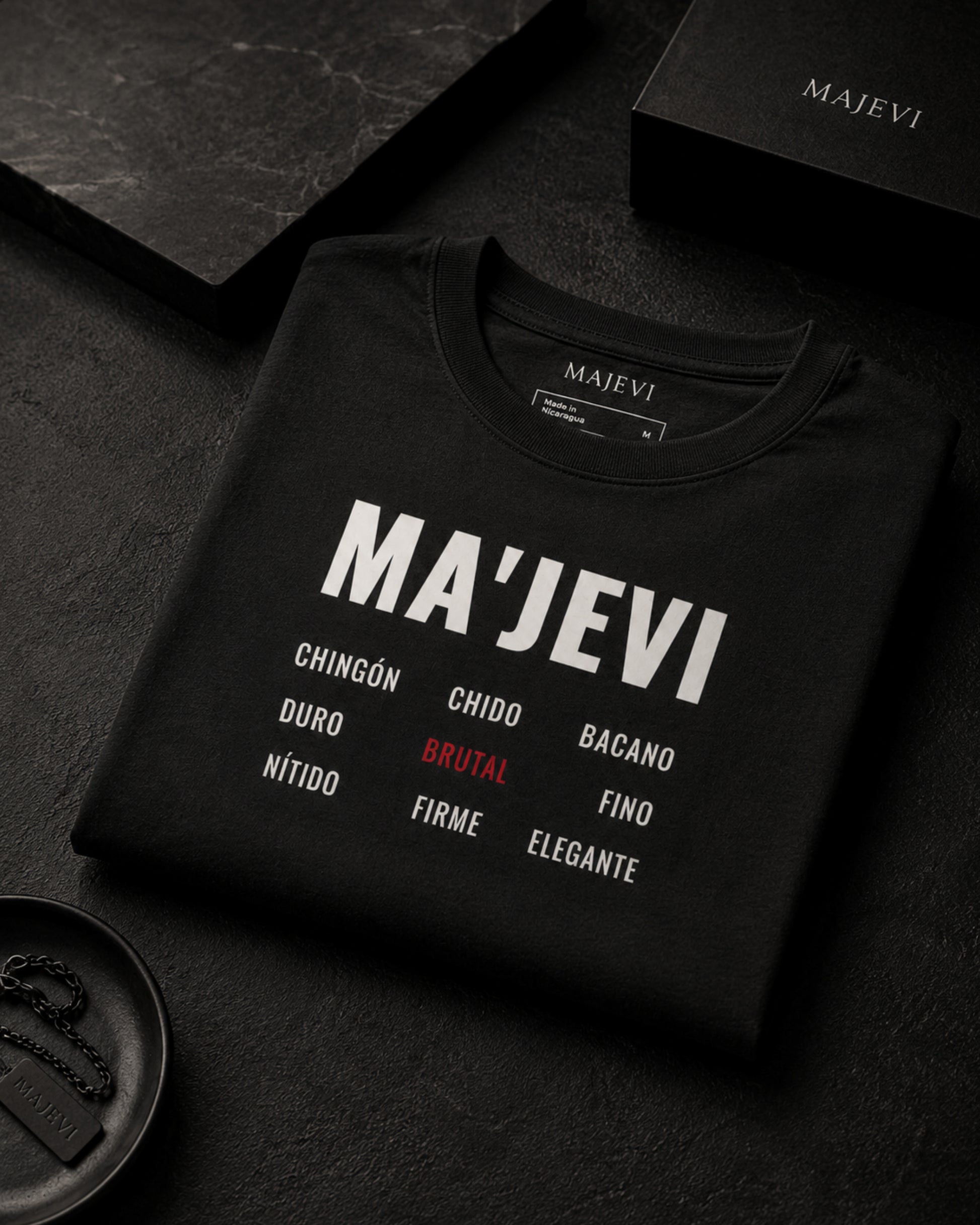 Black sweatshirt with 'MA'JEVI' branding and text on a dark surface