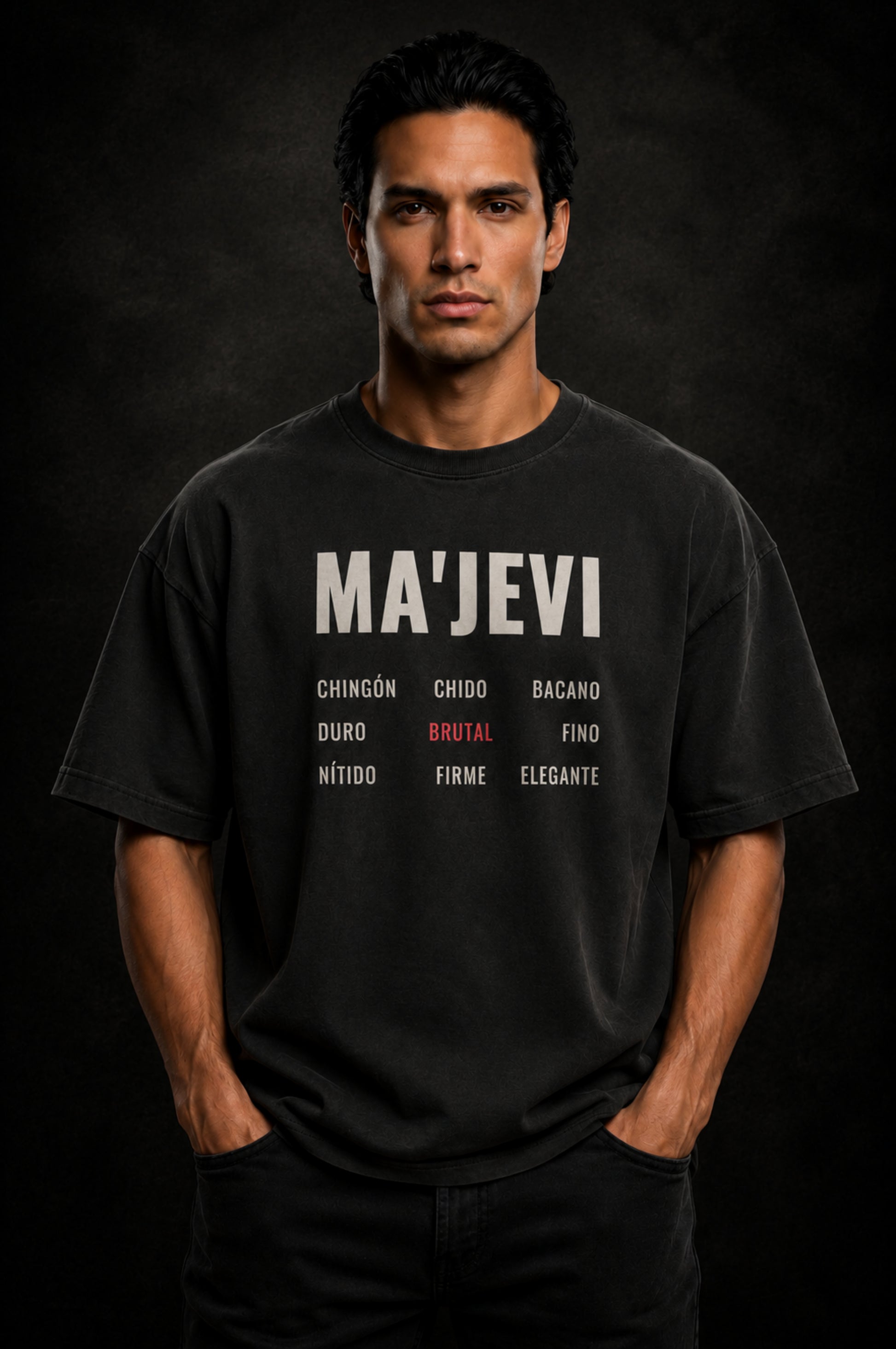 Man wearing a washed black t-shirt with 'MA'JEVI' text on a dark background