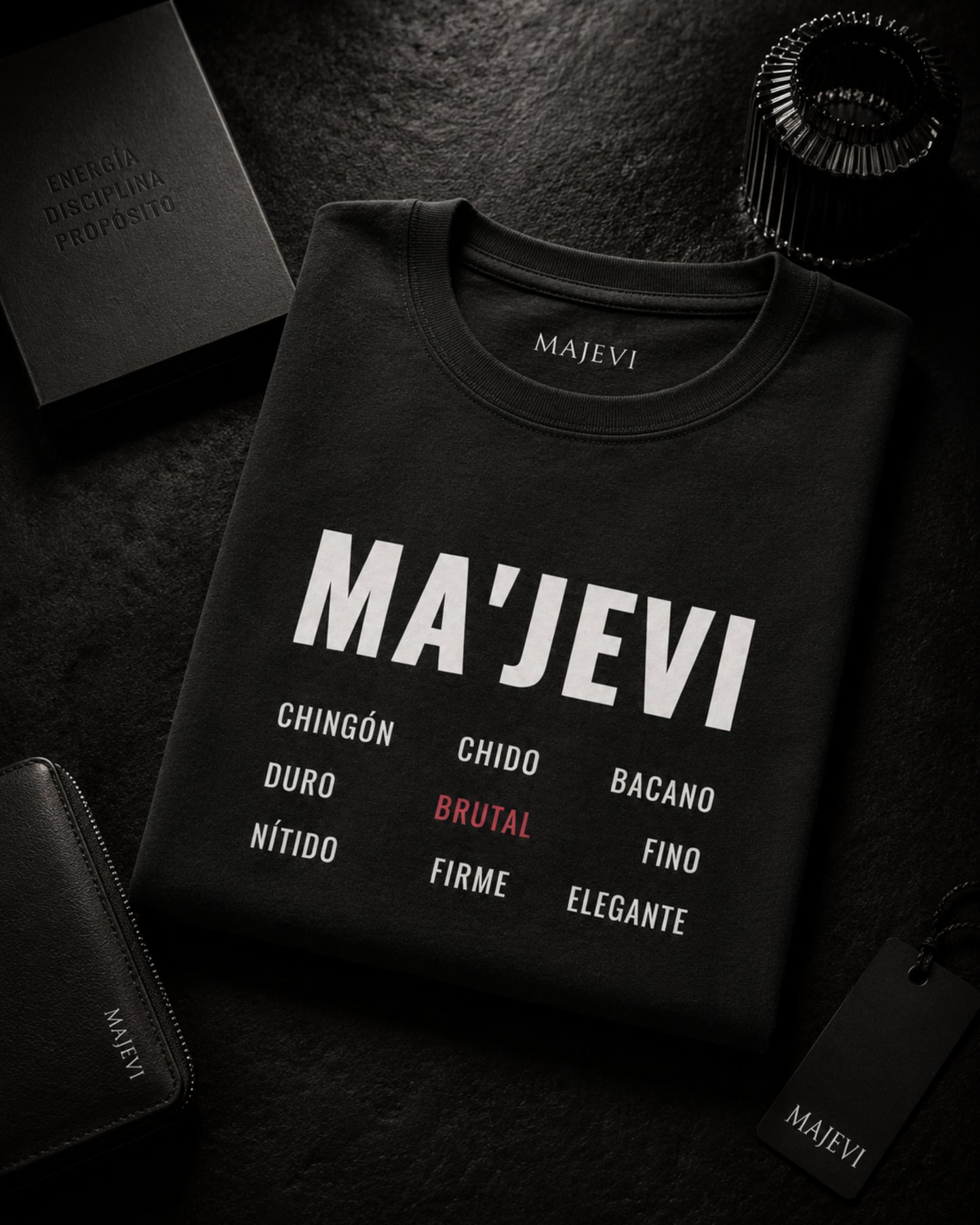 Black sweatshirt with 'MA'JEVI' text and brand name on a dark surface