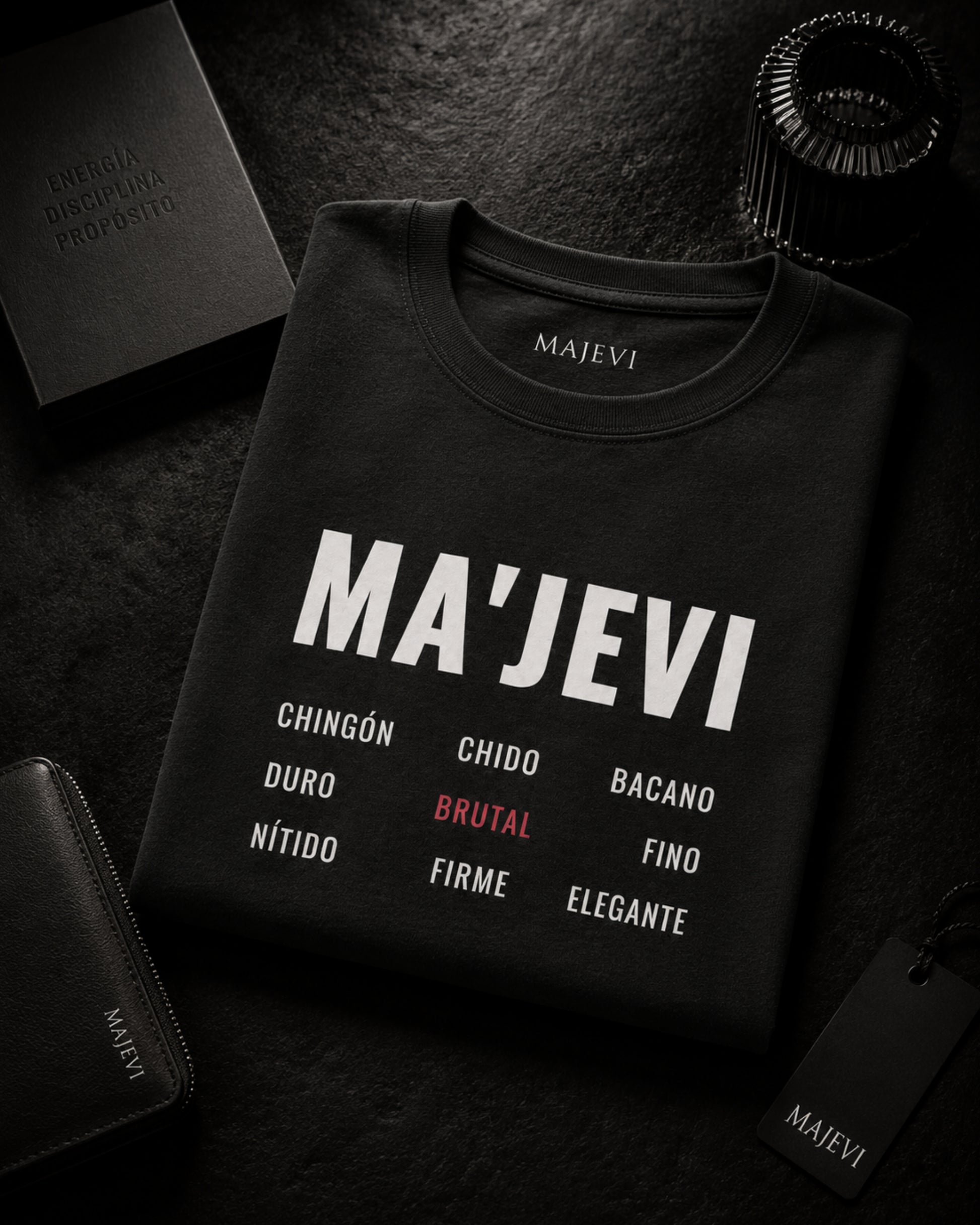 Black sweatshirt with 'MA'JEVI' text and brand name on a dark surface