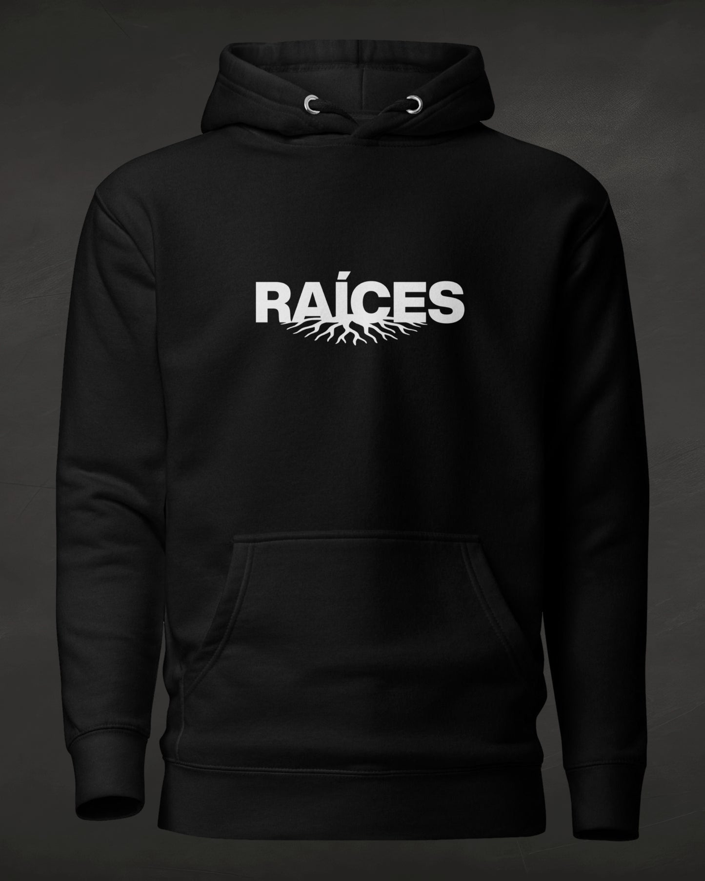 Black hoodie with 'RAÓCES' text on a dark background