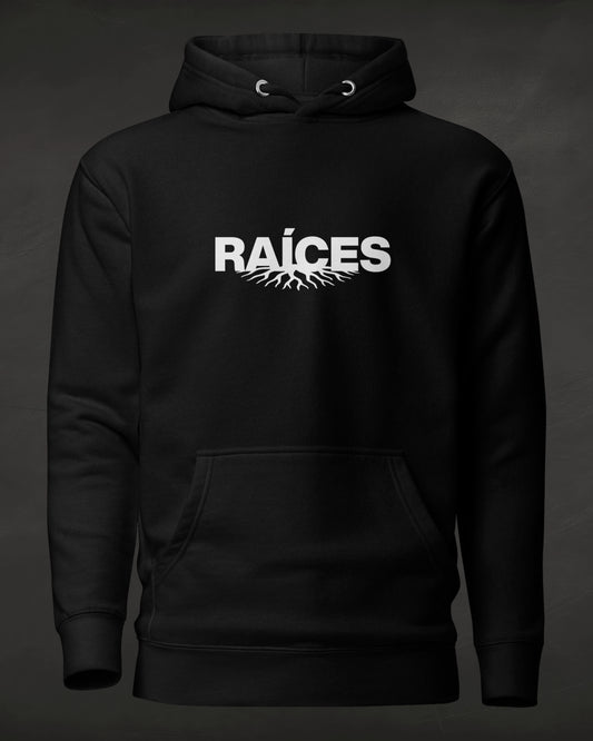 Black hoodie with 'RAÓCES' text on a dark background