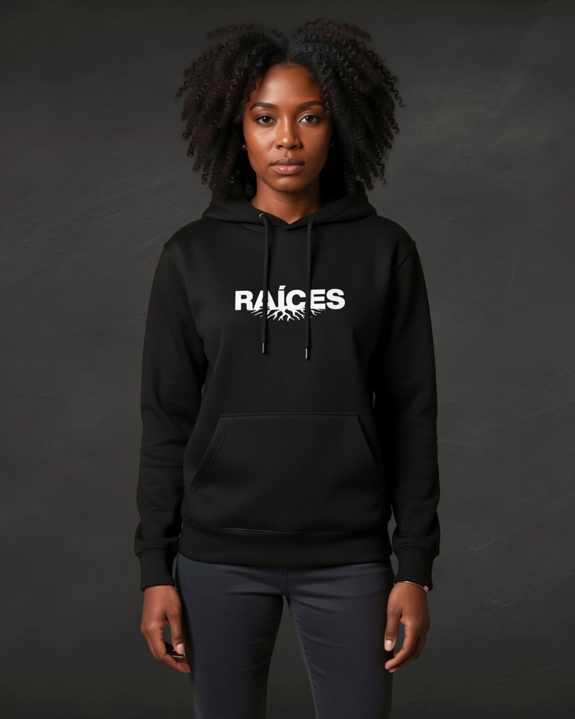 Person wearing a black hoodie with 'RAICES' logo on a dark background